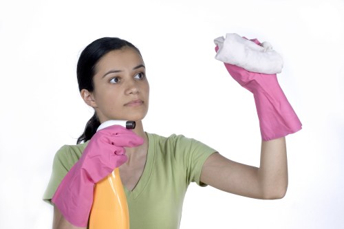 Technician using steam cleaning equipment on a carpeted hallway in Tokyngton